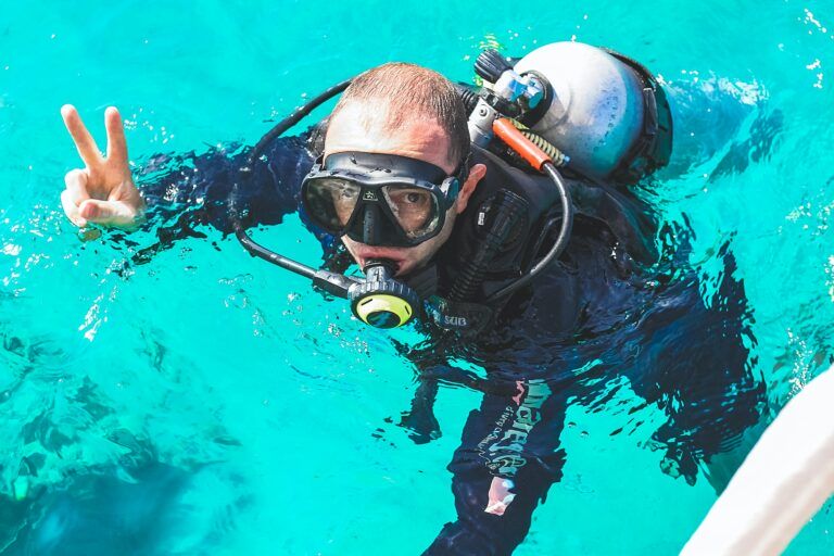 A young man is diving. Swims in a diving suit. Extreme sport. Diving.