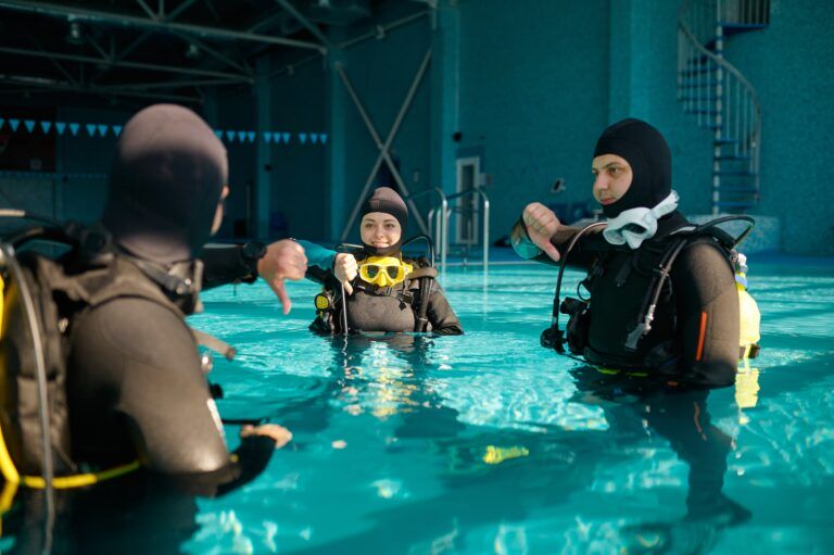 Instructor and two divers, lesson in diving school